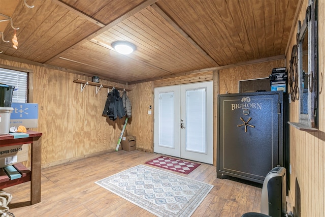 interior space with wooden ceiling, wood-type flooring, wooden walls, and french doors