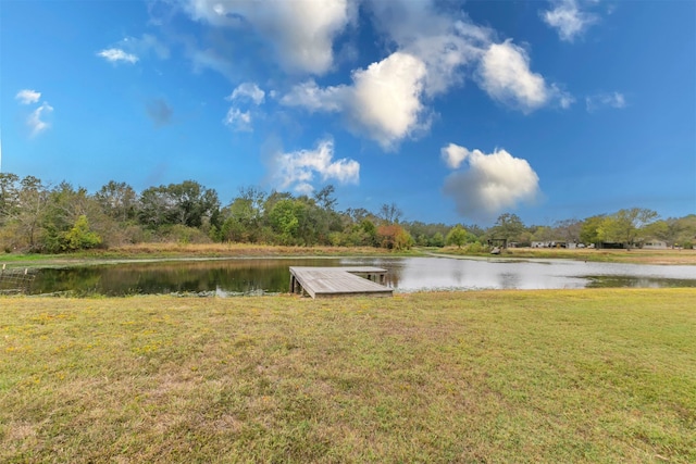 view of dock featuring a water view and a lawn