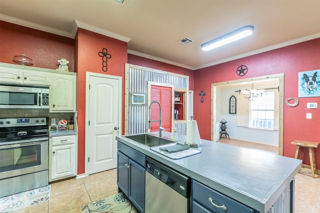 kitchen with crown molding, sink, a kitchen island, and appliances with stainless steel finishes