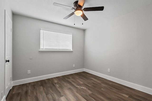 empty room with dark hardwood / wood-style floors and ceiling fan