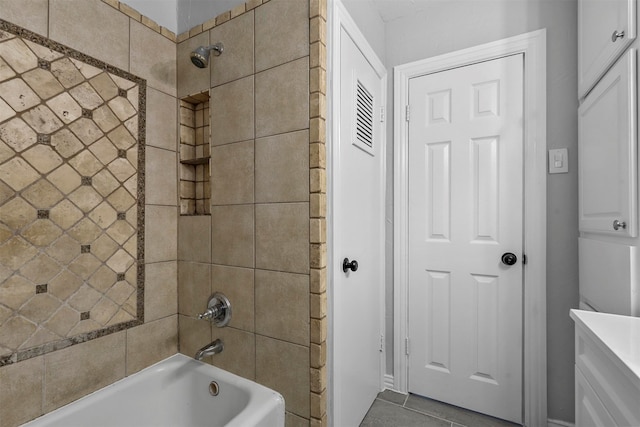 bathroom featuring tiled shower / bath combo and tile patterned floors