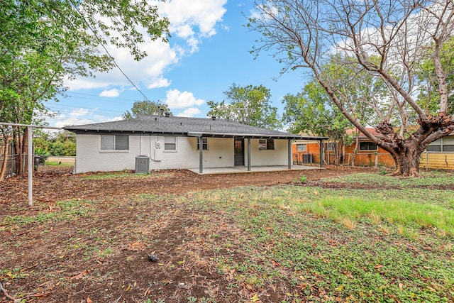 rear view of house with cooling unit and a patio