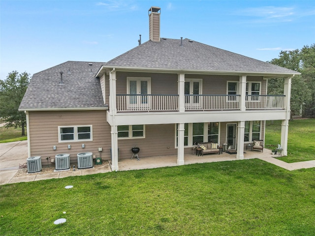 rear view of property featuring central AC, a balcony, a patio area, a yard, and an outdoor living space