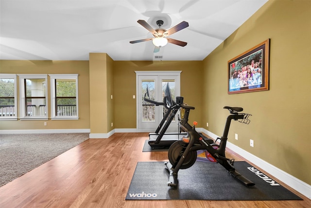 exercise room featuring ceiling fan and light hardwood / wood-style flooring