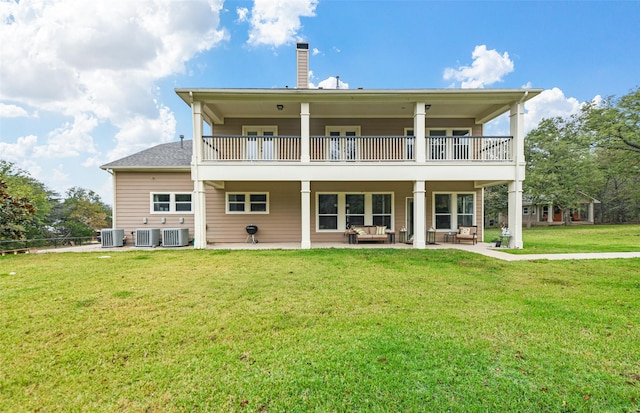 rear view of property featuring a yard, central AC, and a patio