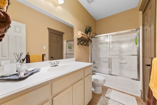 full bathroom with toilet, bath / shower combo with glass door, tile patterned flooring, and vanity