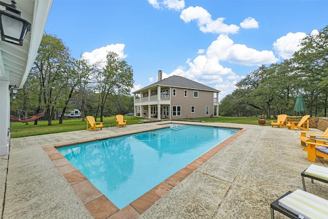 view of pool featuring a yard and a patio