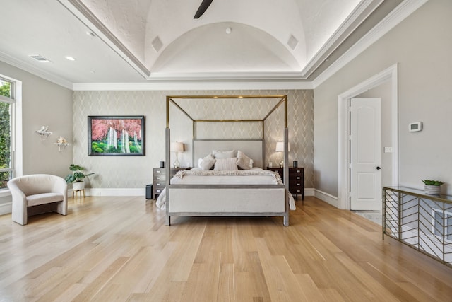 bedroom with ceiling fan, light wood-type flooring, vaulted ceiling, and ornamental molding