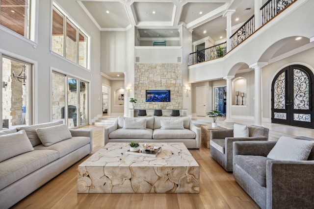6800 Rainwood Dr, Plano, TX 75024 - living area with a high ceiling, decorative columns, arched walkways, recessed lighting, and ornamental molding