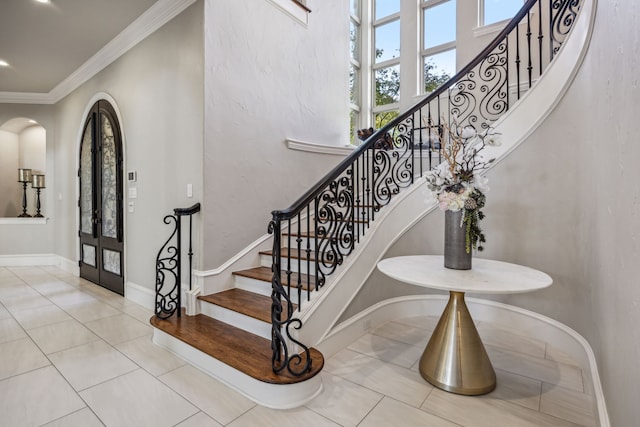 6800 Rainwood Dr, Plano, TX 75024 - staircase featuring plenty of natural light, ornamental molding, tile patterned flooring, baseboards, and arched walkways