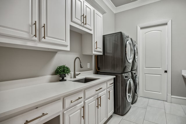 laundry room featuring cabinets, sink, ornamental molding, light tile patterned floors, and stacked washer / dryer