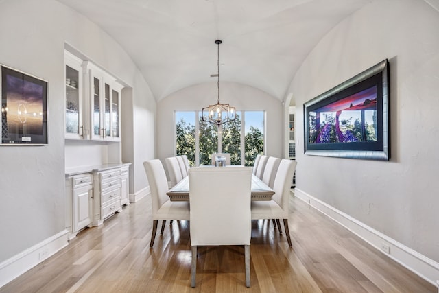 6800 Rainwood Dr, Plano, TX 75024 - dining room featuring light wood-type flooring, a chandelier, baseboards, and lofted ceiling
