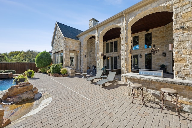 view of patio featuring area for grilling and an outdoor bar