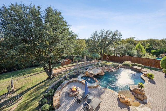 view of pool featuring an outdoor fire pit, a lawn, and a patio area