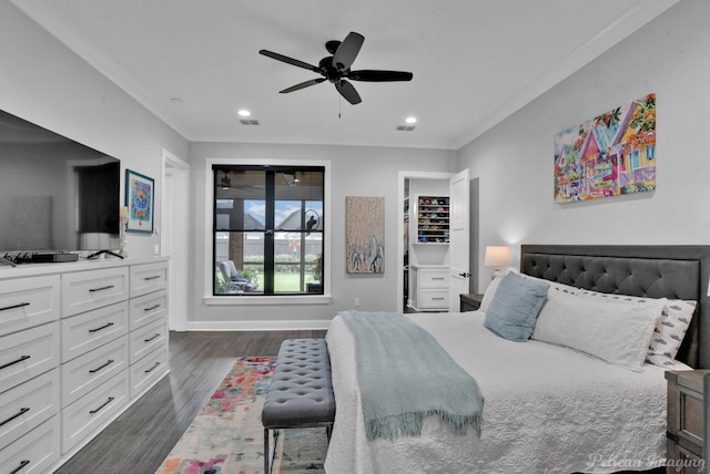 bedroom with dark hardwood / wood-style flooring, ceiling fan, and ornamental molding