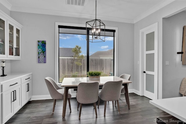 dining space with ornamental molding, dark hardwood / wood-style floors, and a chandelier