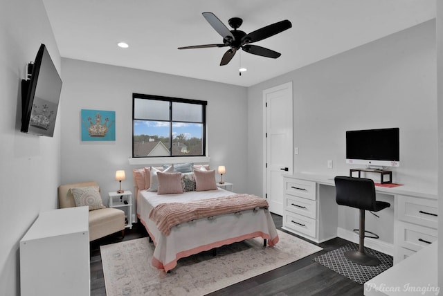 bedroom featuring dark wood-type flooring, built in desk, and ceiling fan