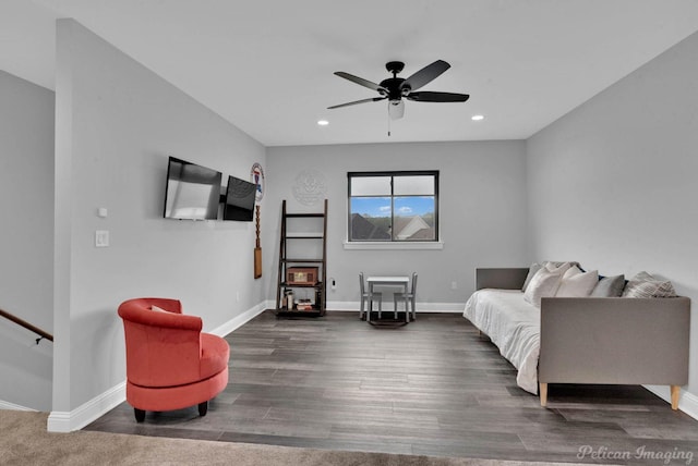 living room featuring ceiling fan and dark wood-type flooring