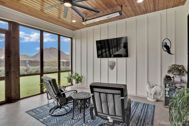 sunroom / solarium featuring ceiling fan and wooden ceiling