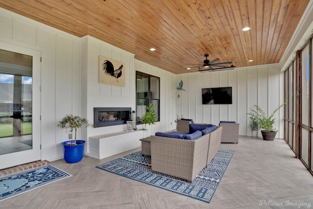 view of patio / terrace featuring an outdoor living space with a fireplace and ceiling fan