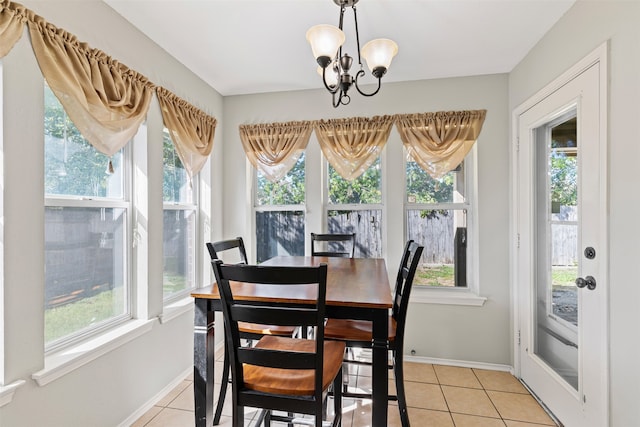 tiled dining room with a wealth of natural light and a notable chandelier