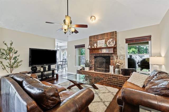 living room featuring hardwood / wood-style flooring, ceiling fan, and a fireplace