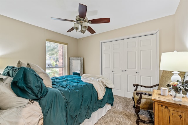 carpeted bedroom featuring ceiling fan and a closet