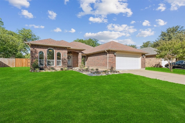 view of front of property with a garage and a front yard