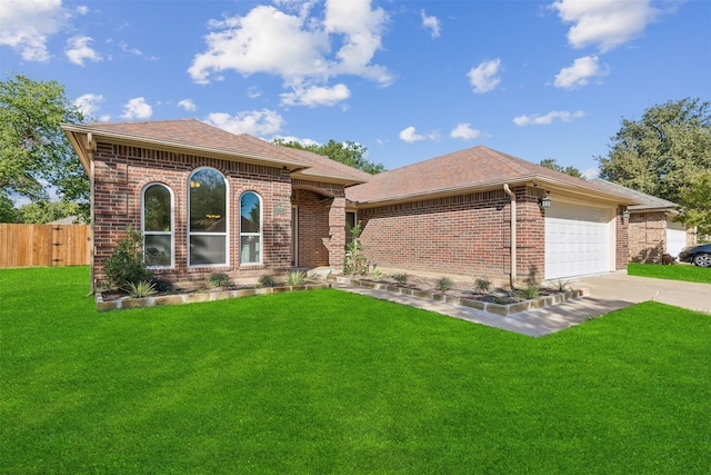 view of front of property with a garage and a front lawn