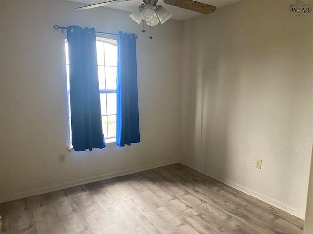 unfurnished room with light wood-type flooring and ceiling fan