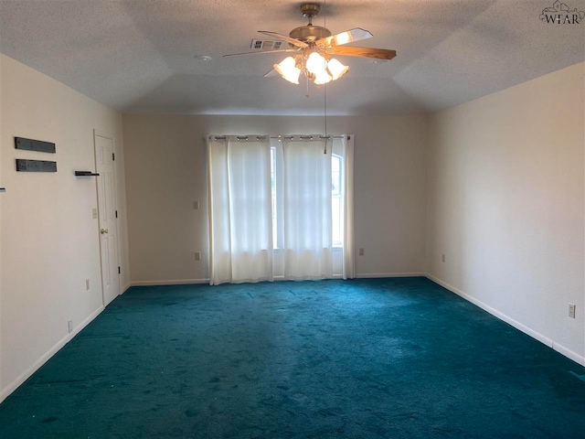 carpeted spare room with a textured ceiling, ceiling fan, and vaulted ceiling