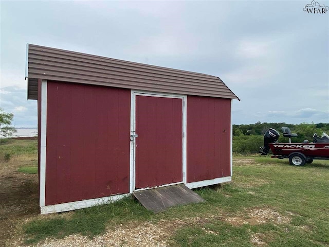 view of outbuilding with a lawn