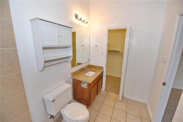 bathroom featuring toilet, vanity, and tile patterned floors