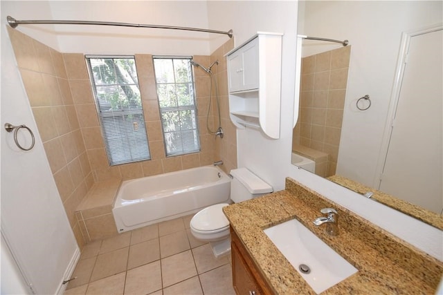 full bathroom featuring toilet, vanity, tiled shower / bath, and tile patterned floors