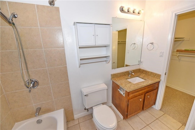 full bathroom featuring toilet, tiled shower / bath combo, vanity, and tile patterned flooring