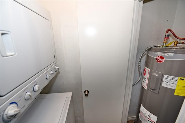 washroom featuring electric water heater and stacked washer and dryer