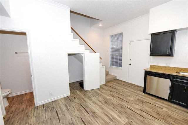 kitchen with dishwasher, light wood-type flooring, a textured ceiling, and crown molding