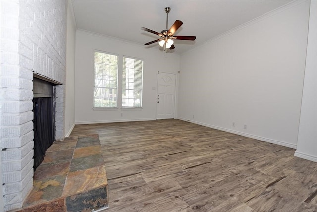 living room with ceiling fan, hardwood / wood-style floors, crown molding, and a fireplace