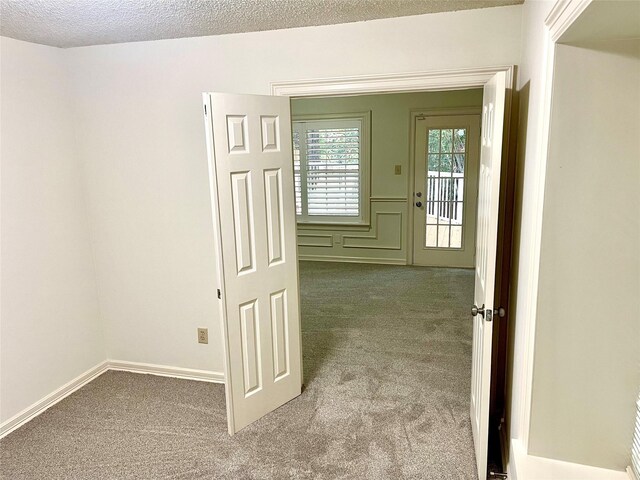 bathroom with toilet, a textured ceiling, and separate shower and tub