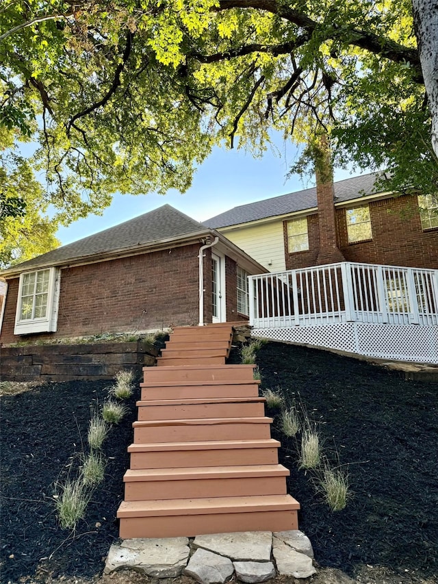 view of side of property featuring a wooden deck