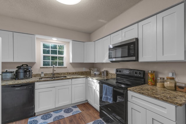 kitchen featuring white cabinets, sink, black appliances, and dark hardwood / wood-style flooring