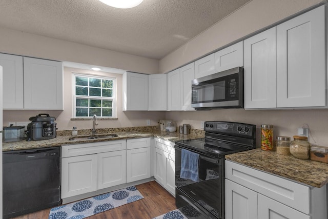628 Annarose Dr, Dallas, TX 75232 - kitchen featuring black appliances, a sink, a textured ceiling, and white cabinetry