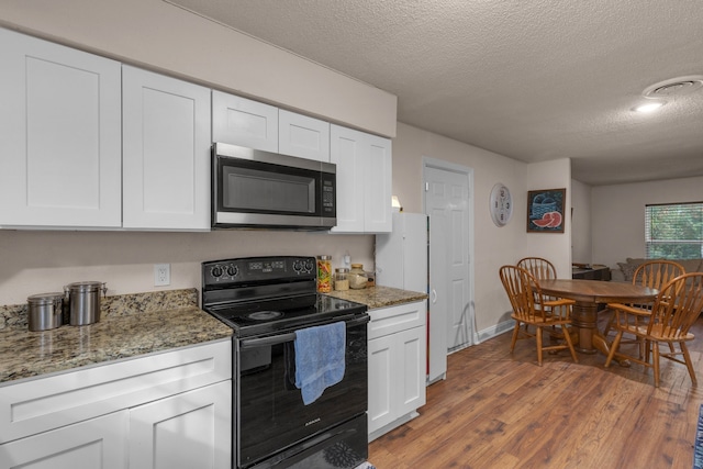 kitchen with white cabinets, black / electric stove, wood-type flooring, and stone counters