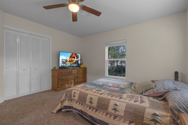 carpeted bedroom featuring a closet and ceiling fan