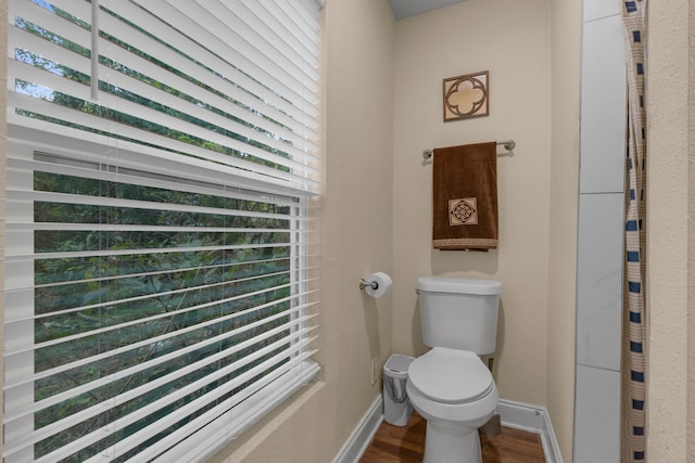 bathroom featuring hardwood / wood-style floors and toilet