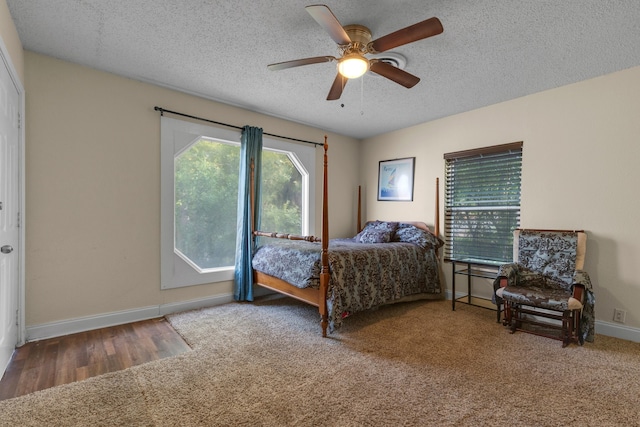 bedroom featuring ceiling fan, a textured ceiling, and carpet floors