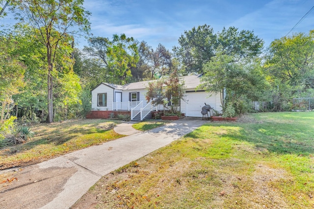 ranch-style house featuring a garage and a front yard