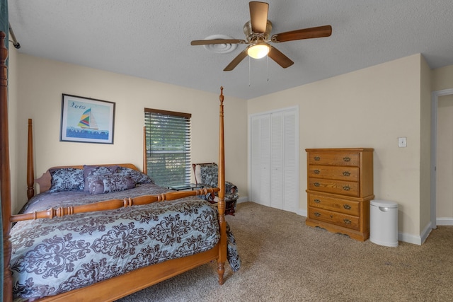 bedroom with carpet flooring, a textured ceiling, ceiling fan, and a closet