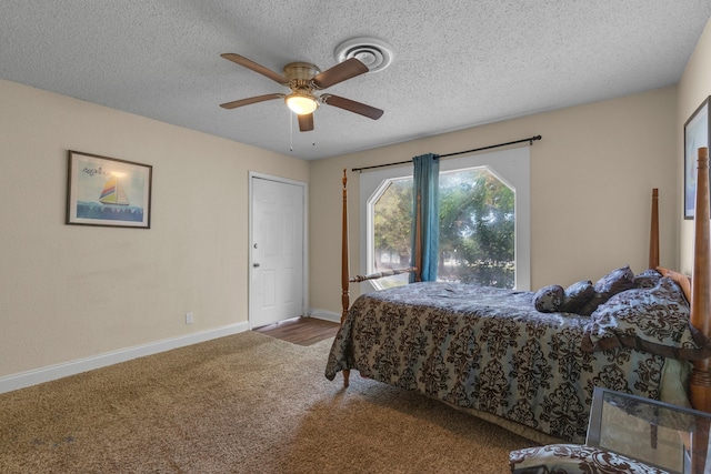 bedroom featuring a textured ceiling, ceiling fan, and carpet floors