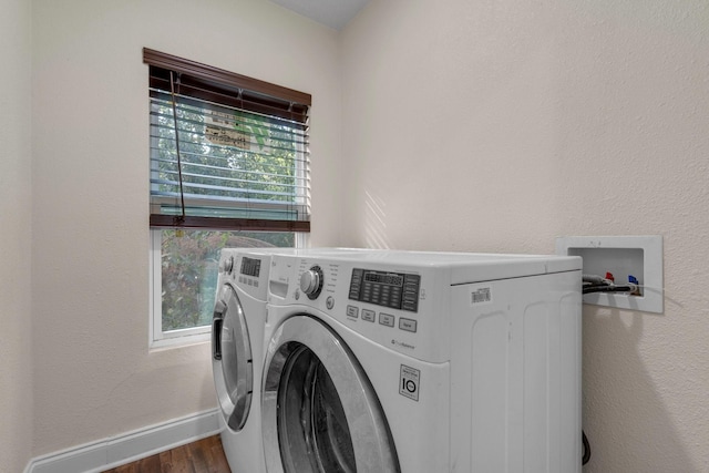 628 Annarose Dr, Dallas, TX 75232 - laundry area featuring washer and dryer, wood finished floors, healthy amount of natural light, and baseboards